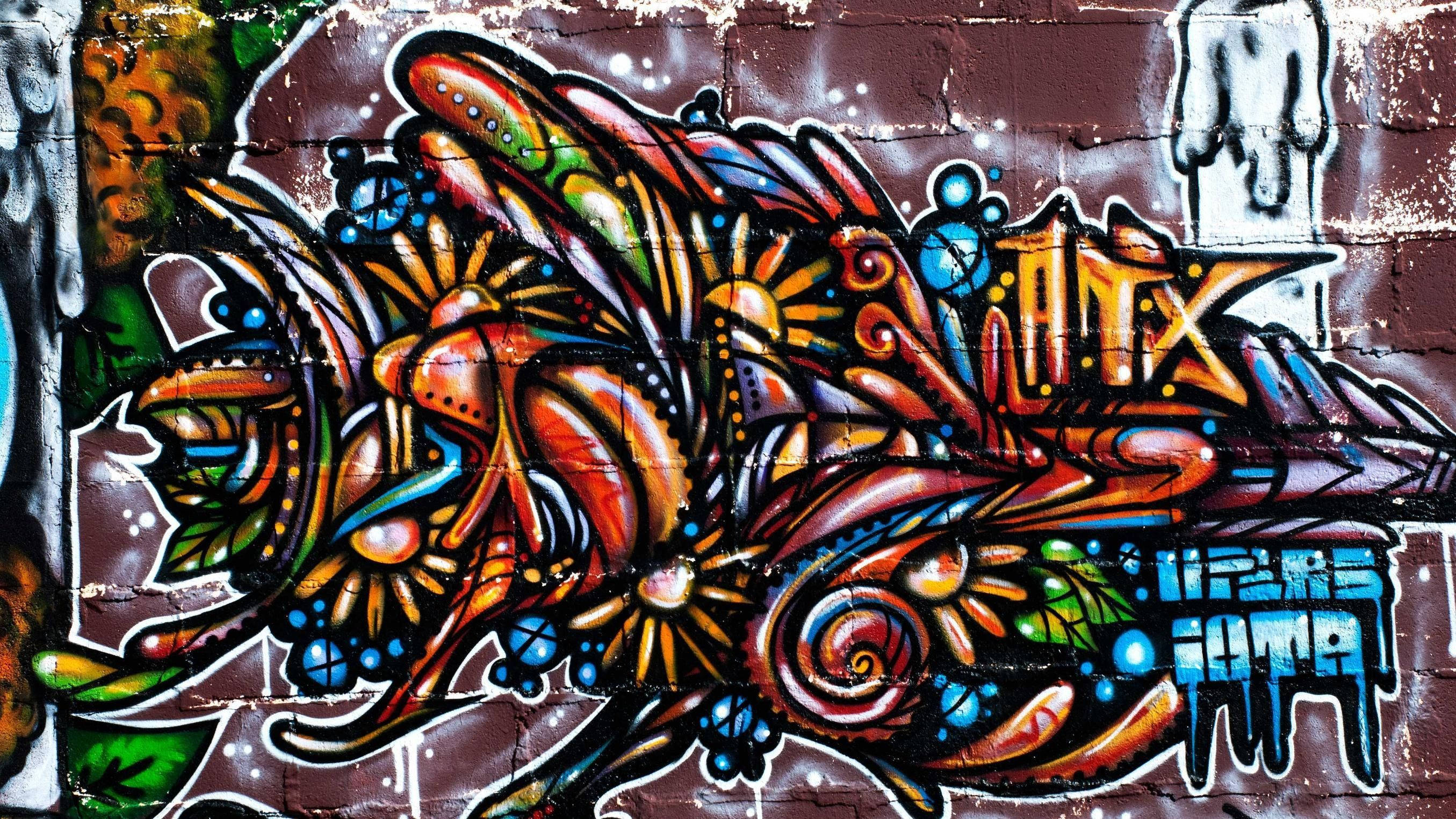 Vibrant Graffiti Flowers On A Laptop Wallpaper