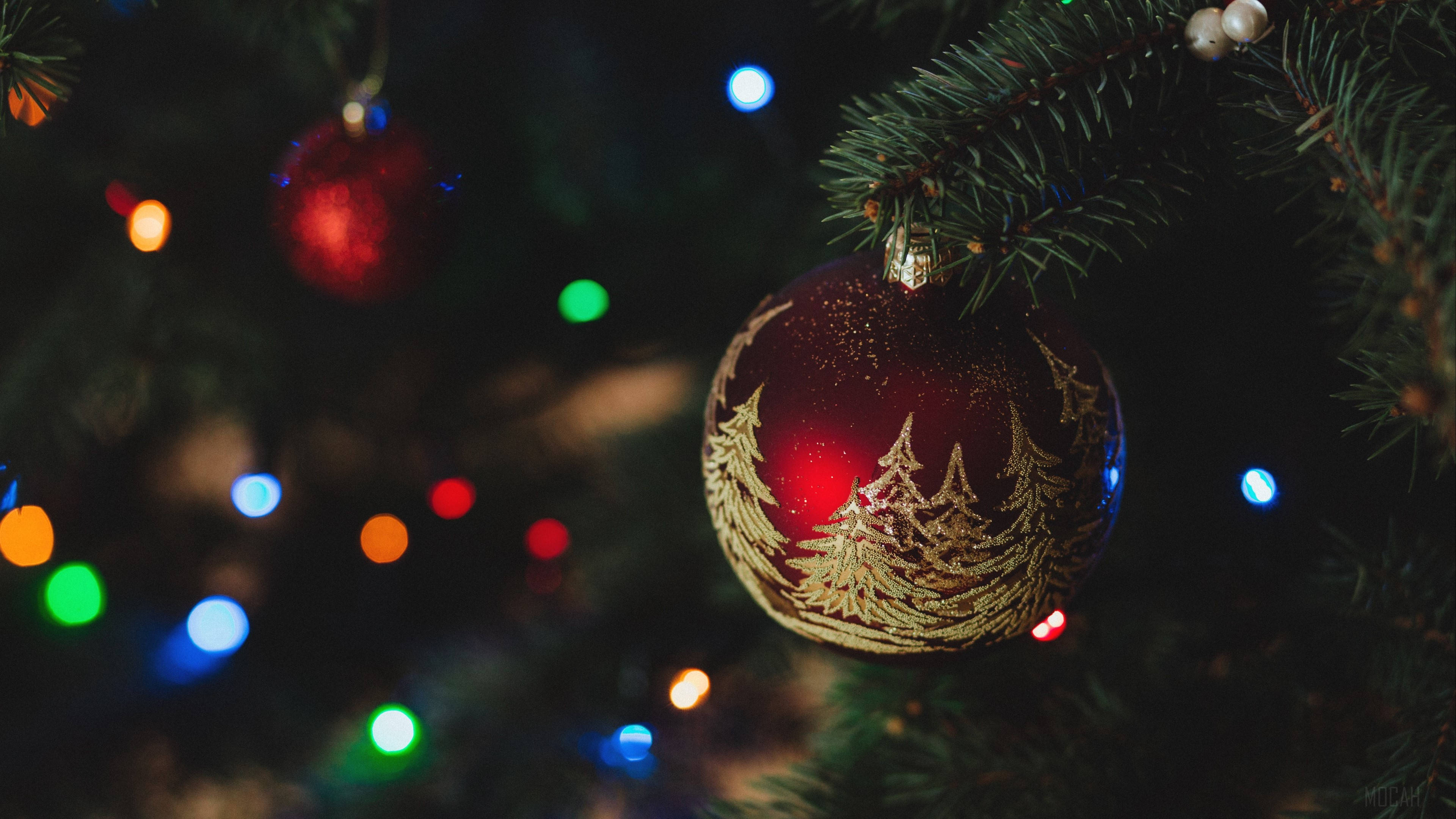 Vibrant Red Christmas Ball On Frosty Table Wallpaper