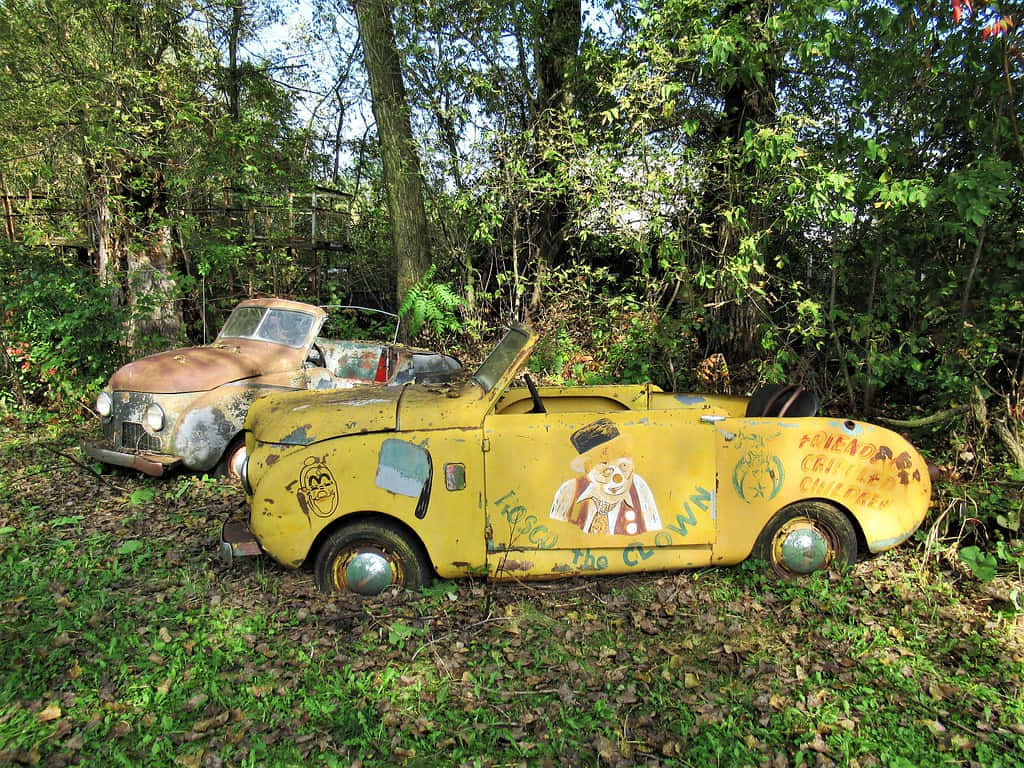 Vintage Clown Themed Car Abandoned Wallpaper