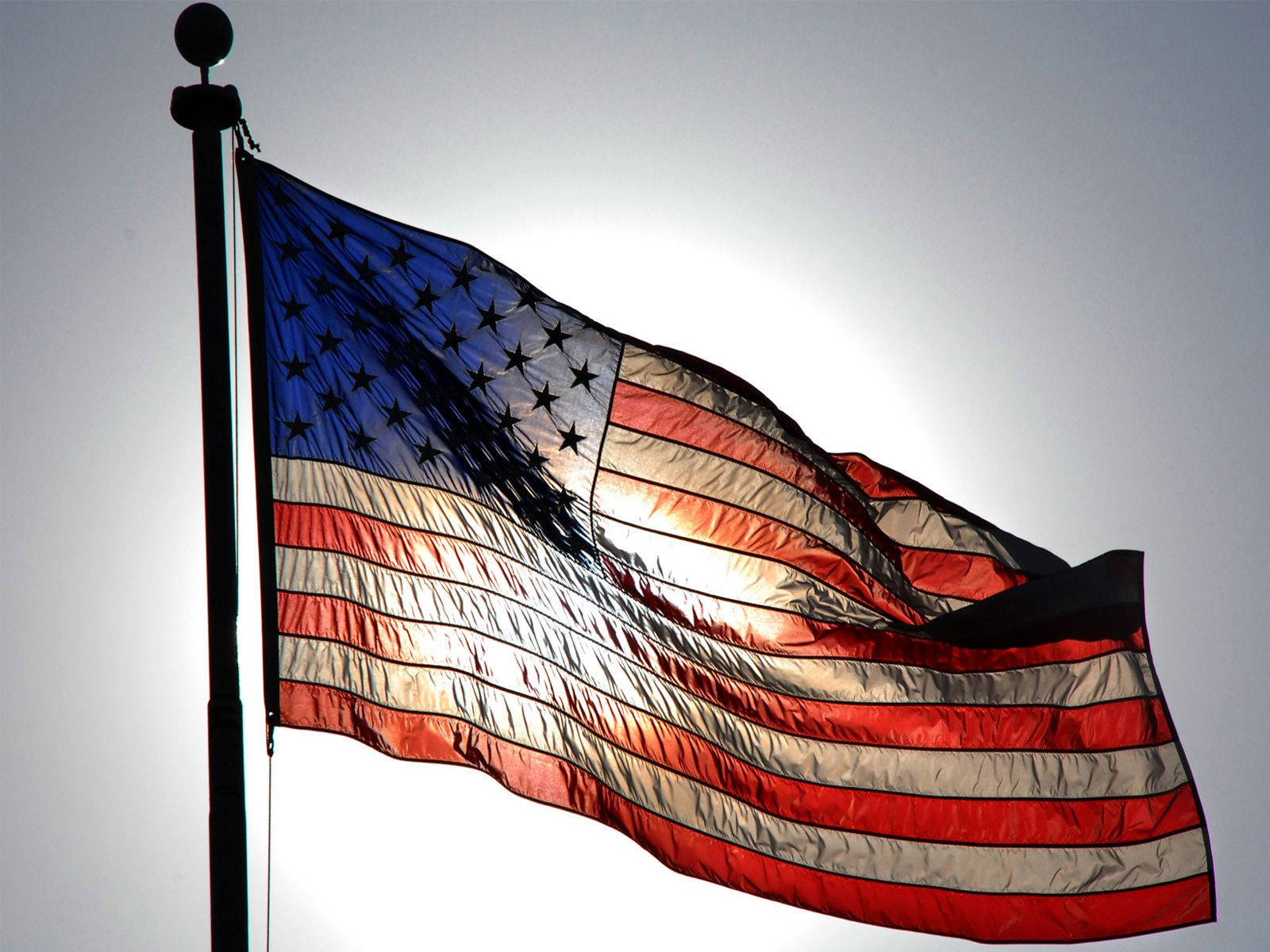 Waving American Flag In The Sun Wallpaper