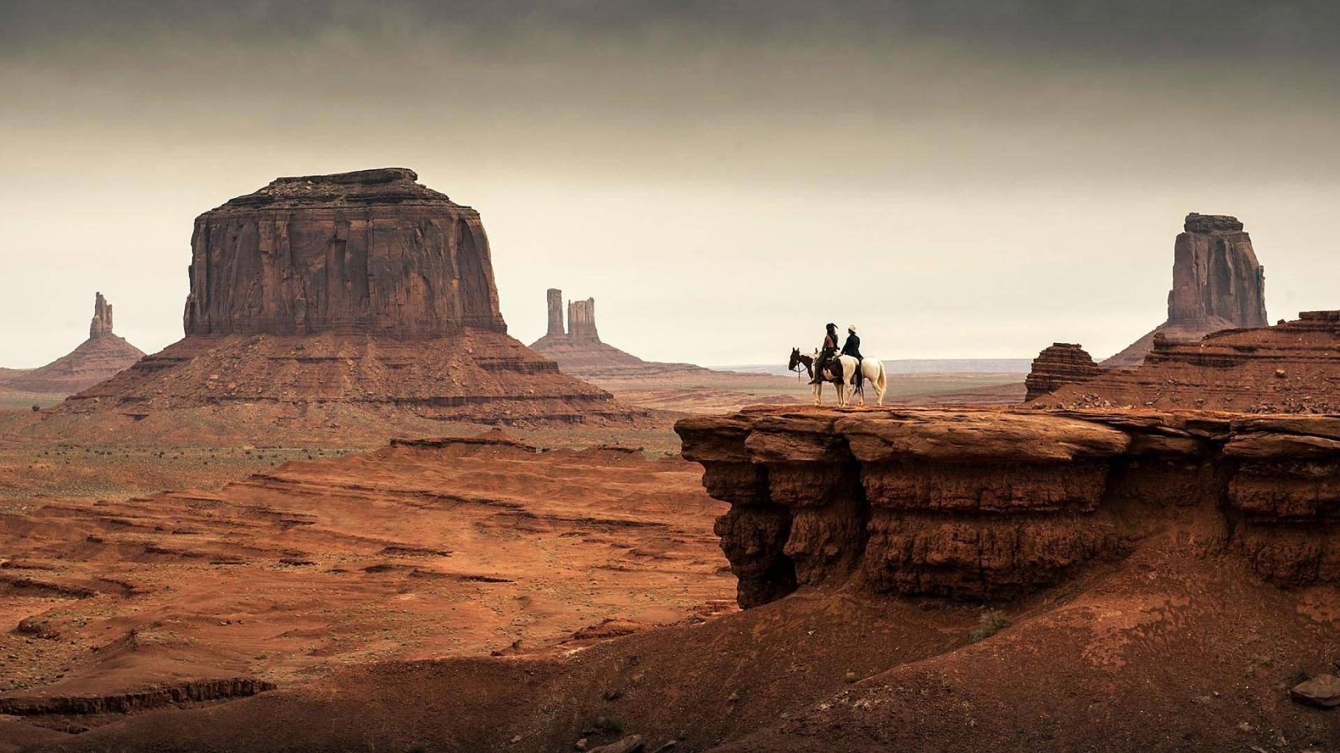 Western Cowboys In Monument Valley Wallpaper