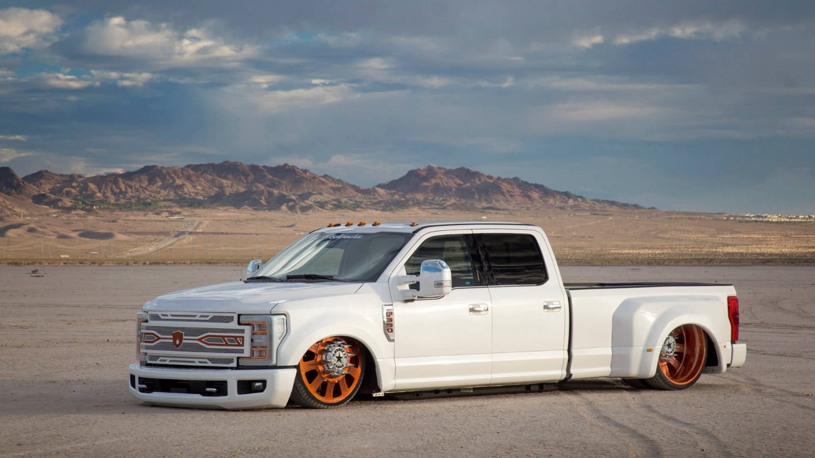 White Dropped Truck On Sand Wallpaper