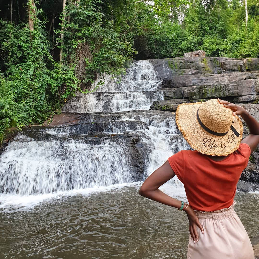 Woman Near The Ivory Coast Waterfall Wallpaper