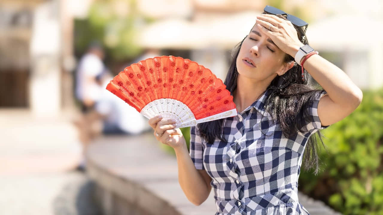 Woman Overheated Fanning Herself.jpg Wallpaper