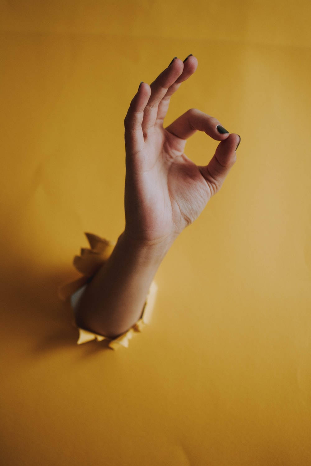 Yellow Wall With Okay Hand Sign Wallpaper