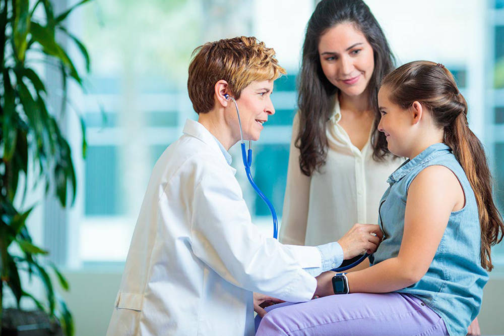 Young Female Patient Looking Optimistic In Hospital Wallpaper