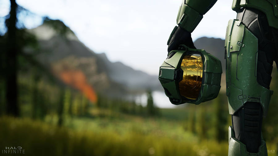 4k Halo Soldier Holding Helmet Wallpaper