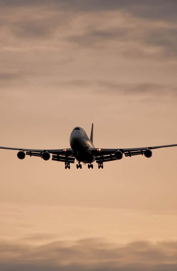 A 747 Airplane Illuminated By Beautiful Lighting Wallpaper