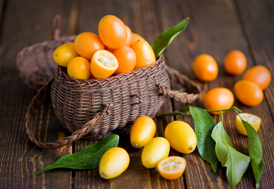 A Basket Of Bright And Fresh Kumquats Wallpaper