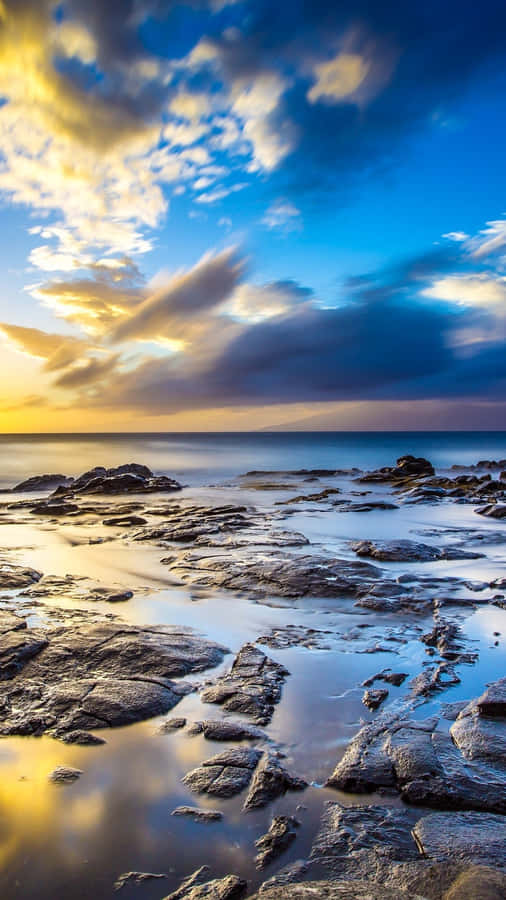 A Beach With Rocks Wallpaper