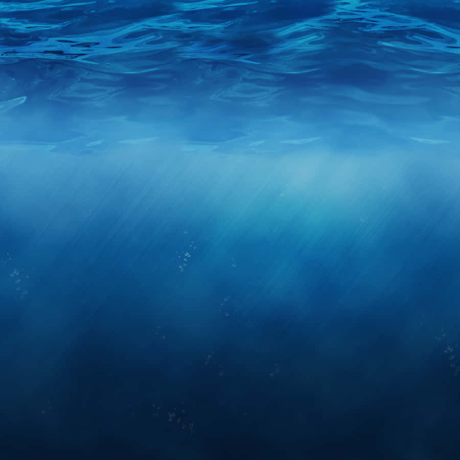 'a Beautiful Beige Ipad Rests Peacefully On A Still Body Of Water.' Wallpaper