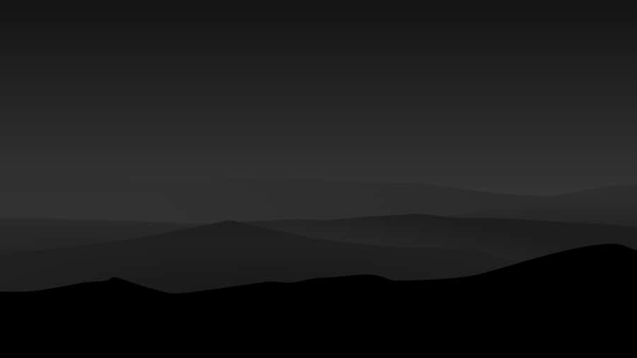 A Black And White Image Of A Mountain Range Wallpaper