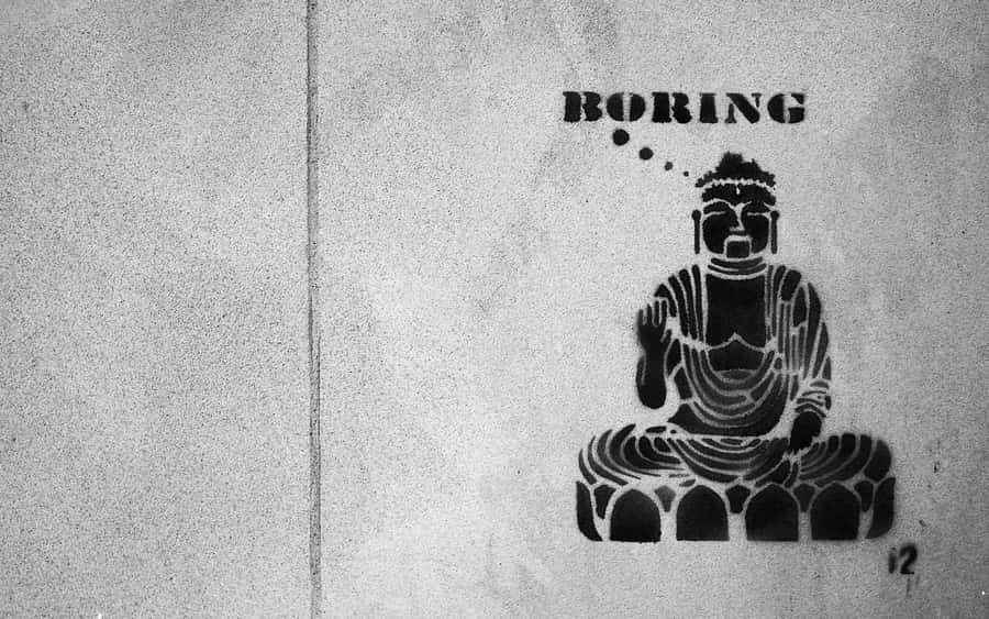A Black And White Photo Of A Buddha Sitting On A Wall Wallpaper
