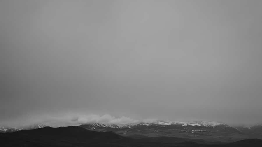 A Black And White Photo Of A Mountain Range Wallpaper