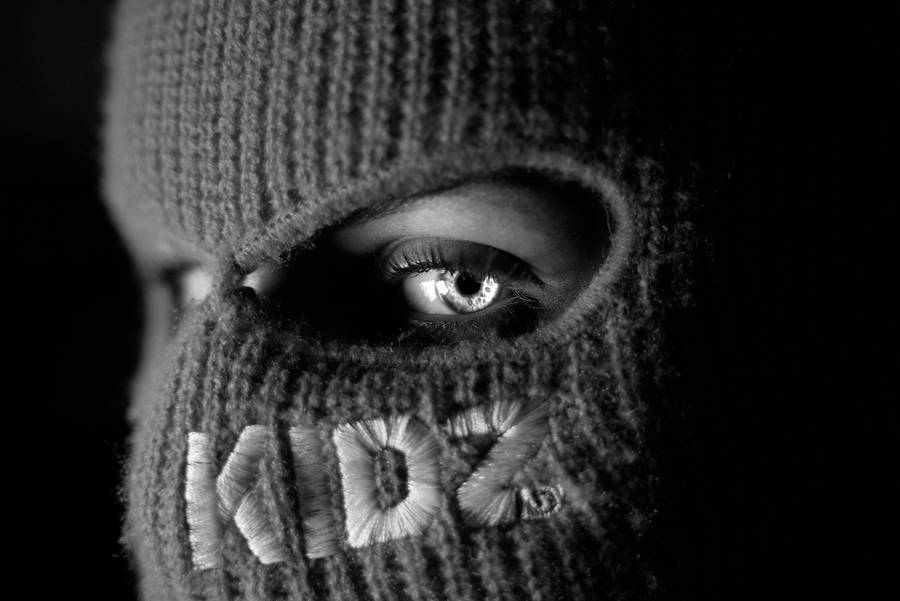 A Black And White Photo Of A Person Wearing A Knitted Mask Wallpaper