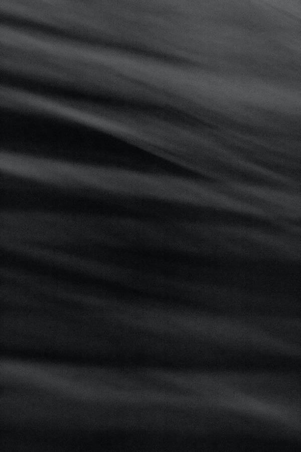 A Black And White Photo Of A Wave Wallpaper