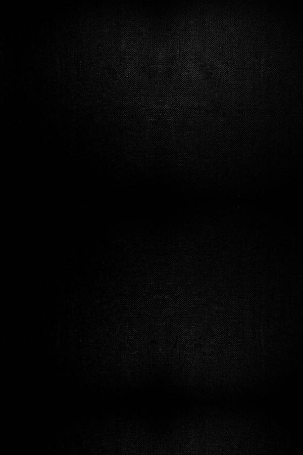 A Black Background With A Light Shining On It Wallpaper
