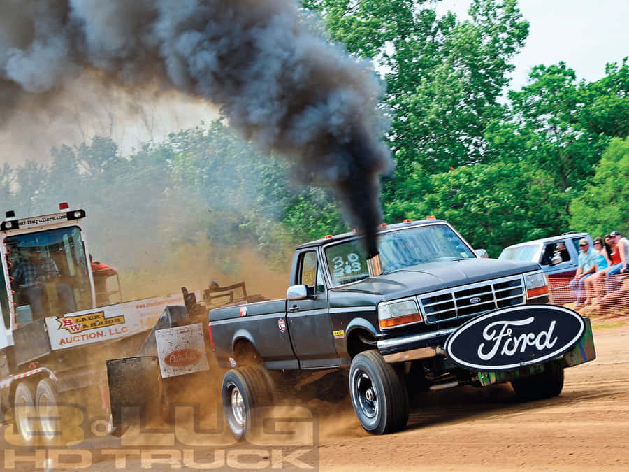 A Black Truck Driving Down A Dirt Road Wallpaper