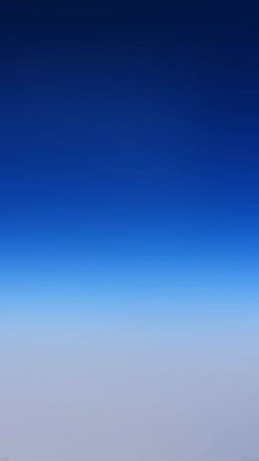 A Blue Sky With Clouds And A Plane Flying Over It Wallpaper