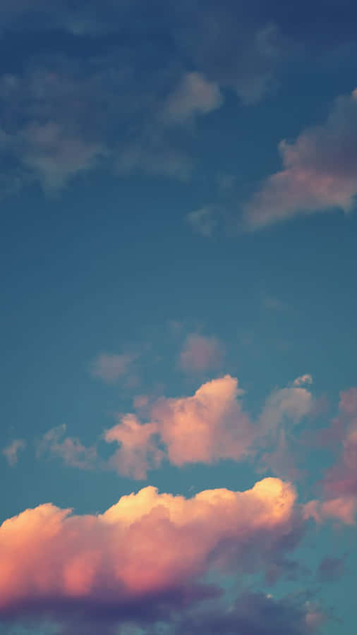 A Blue Sky With Clouds In The Background Wallpaper