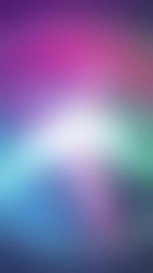 A Blurred Background With A Colorful Light Wallpaper