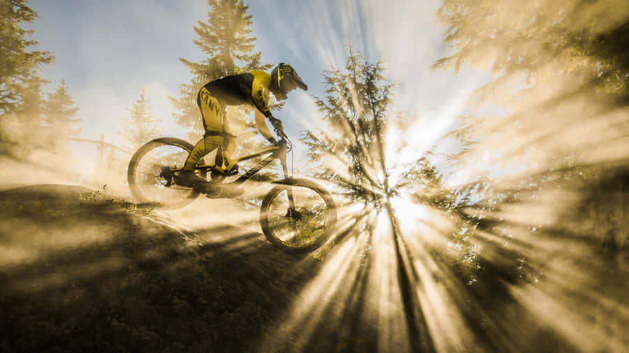 A Bmx Stunt Rider Catching Air At A Skatepark. Wallpaper