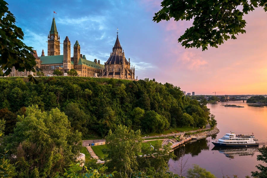 A Boat Docked Near Parliament Hill In Ottawa Wallpaper