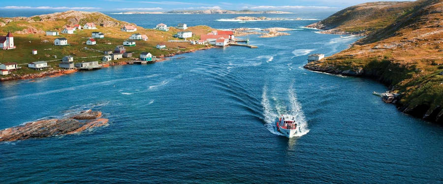 A Boat Passing Through Newfoundland's Coast Wallpaper