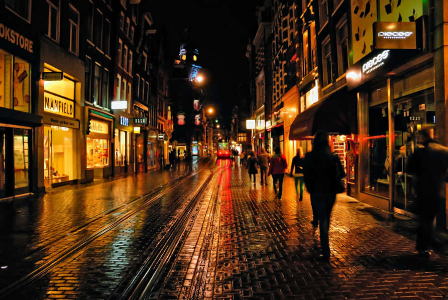 A Brick Street With People Walking Wallpaper