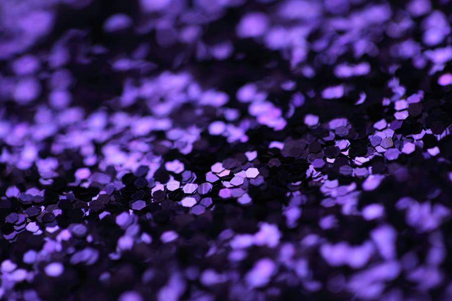 A Brilliant Burst Of Glitter Exploding On A Dark Backdrop. Wallpaper