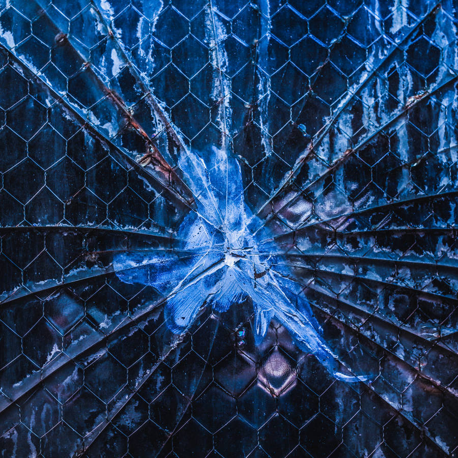 A Broken Wall With Wire Fence Wallpaper