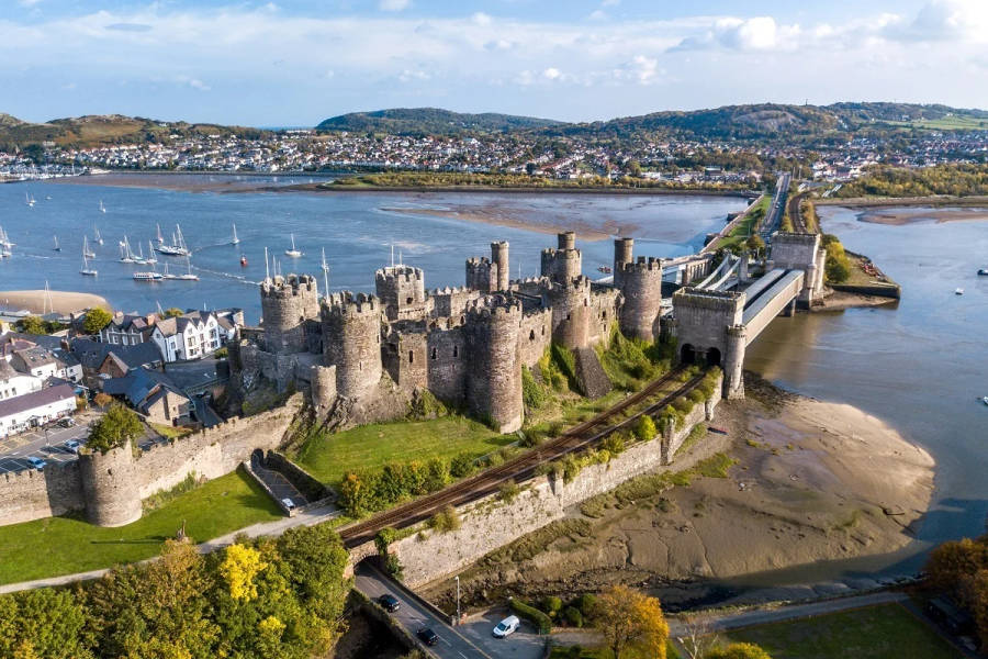 A Castle And A River In Wales Wallpaper