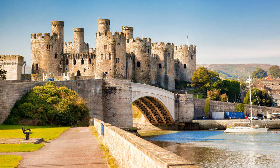 A Castle With Boats On The Water Wallpaper