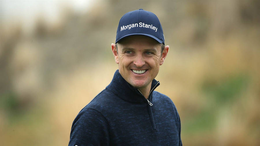 A Cheerful Justin Rose On The Golf Course Wallpaper