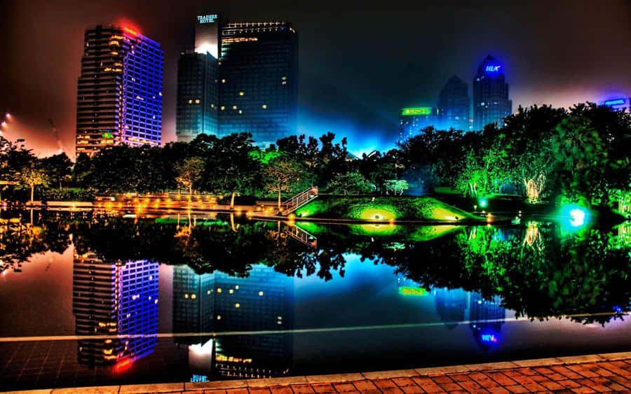 A City At Night With Lights Reflecting In The Water Wallpaper