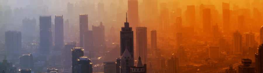 A Cityscape With Buildings And A Sunset Wallpaper