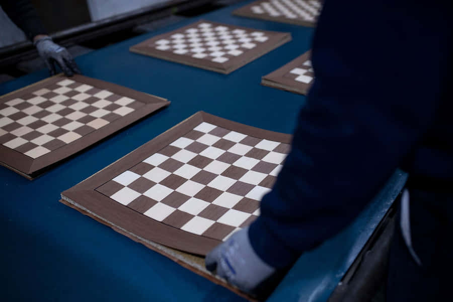A Classic Game Of Chess On A Brown Chessboard Wallpaper