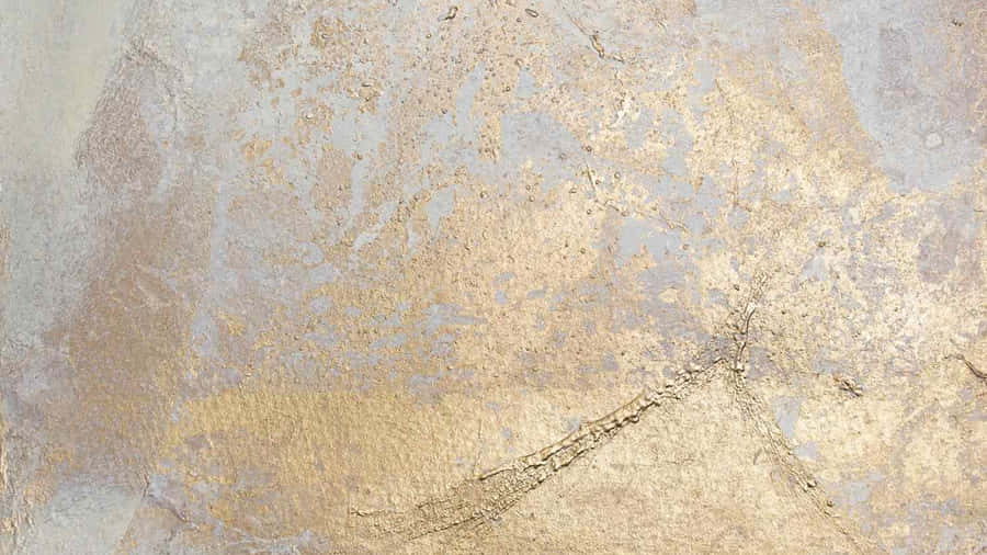 A Close Up Of A Gold And Silver Painted Wall Wallpaper