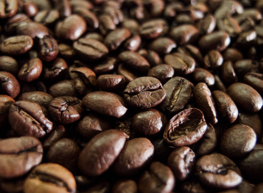 A Close-up View Of High-quality, Dark Roasted Coffee Beans Wallpaper