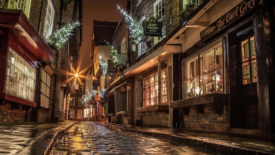 A Cobbled Street With Lights And Decorations Wallpaper