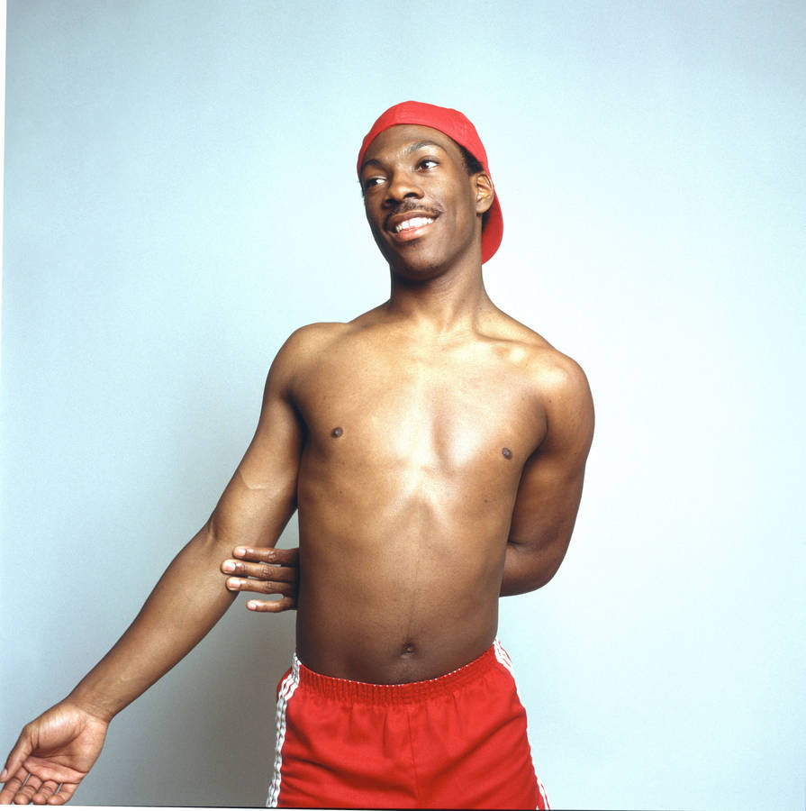 A Confident Eddie Murphy, Exhibiting His Sculptured Physique Shirtless. Wallpaper