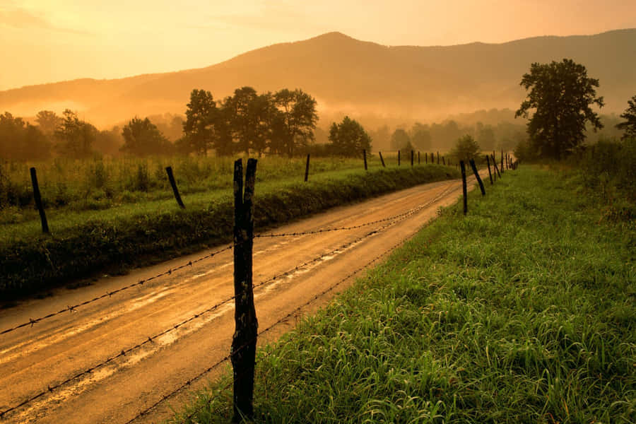 A Cowboy Enjoys A Sunset In The Western Ranch Wallpaper