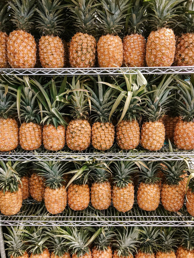 A Delicious Pineapple Ripening On A Shelf Wallpaper