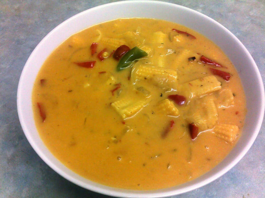 A Delightful Dish Of Yellow Curry With Fresh Baby Corn Wallpaper