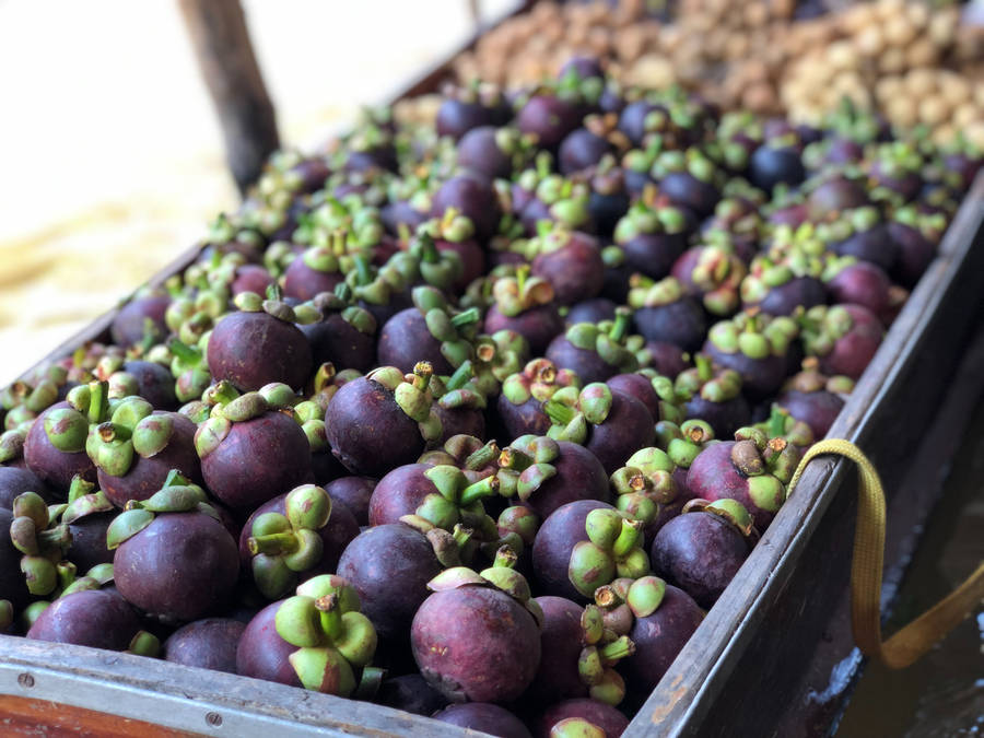 A Fresh Stockpile Of Ripe Mangosteen Fruits Wallpaper