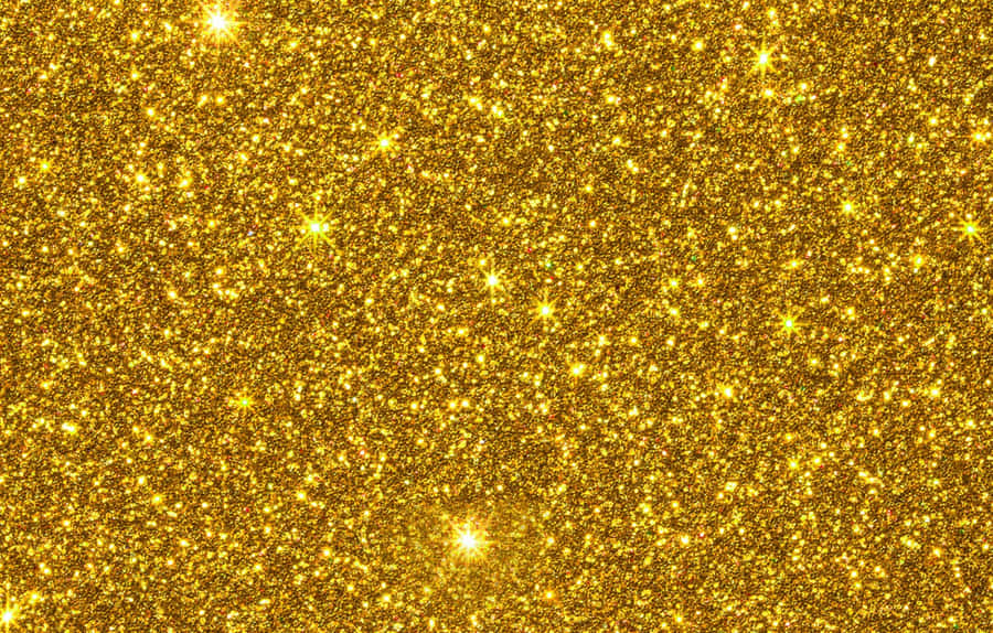 A Gold Glitter Background With Stars Wallpaper