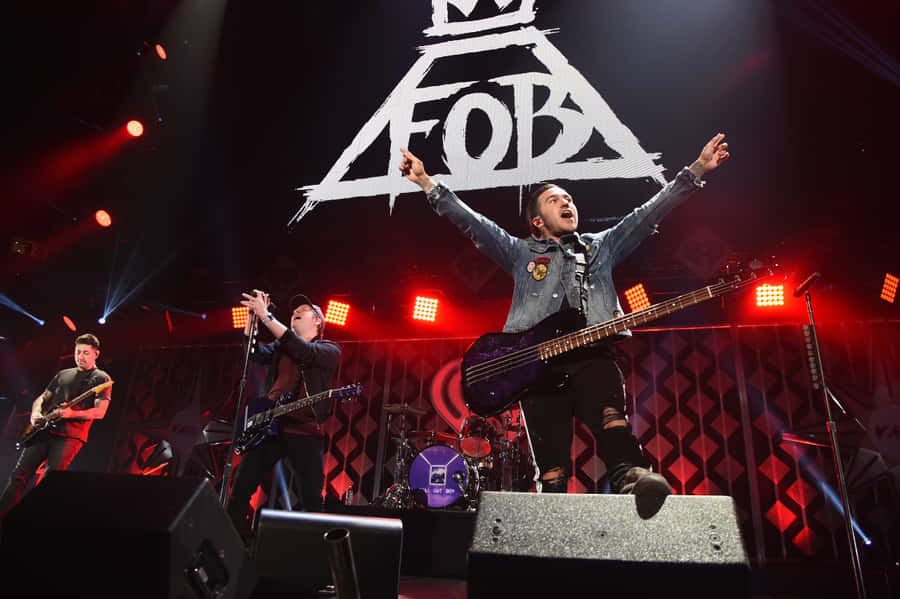 A Group Of Men On Stage With The Fb Logo Wallpaper