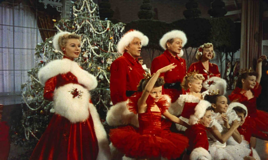 A Group Of People In Santa Suits Posing For A Picture Wallpaper