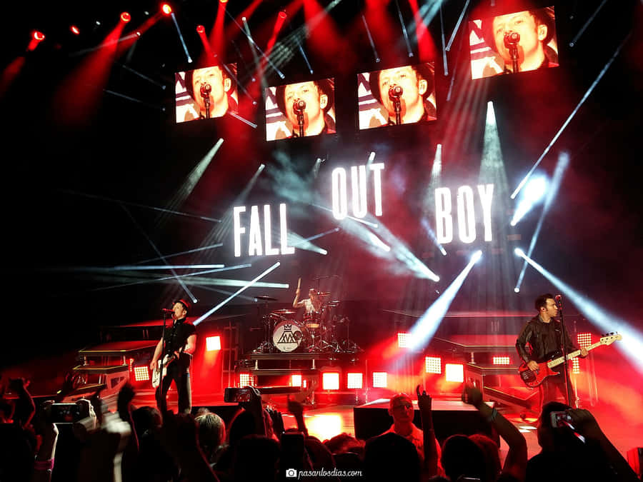 A Group Of People On Stage With Lights On Wallpaper