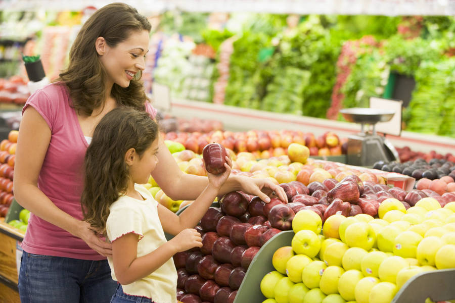 A Healthy Shopping Routine - Mother Buying Fresh Fruits. Wallpaper